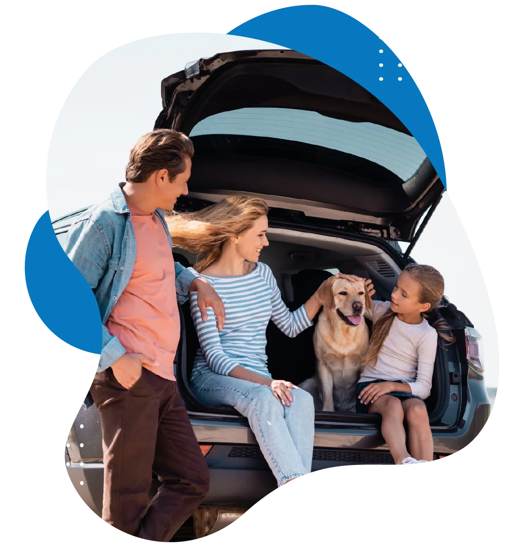 Family with their dog relaxing in the open trunk of their car