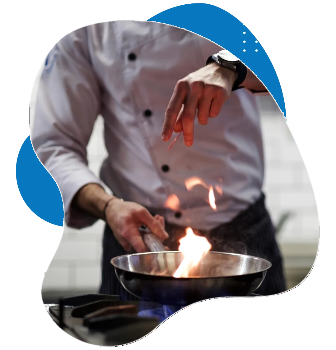 Chef flambéing a dish in a restaurant kitchen