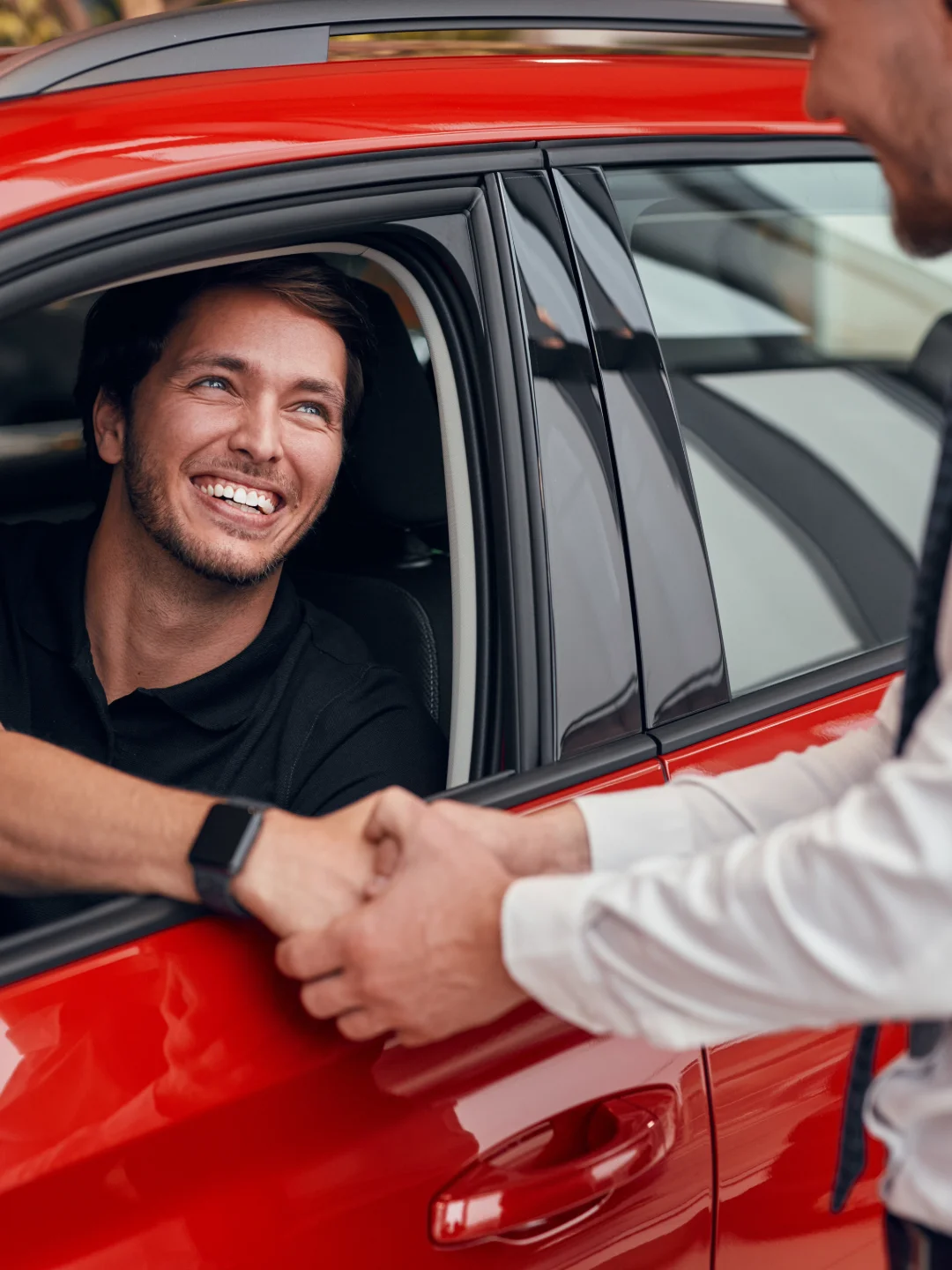 Driver shaking hands through the car window after closing a deal