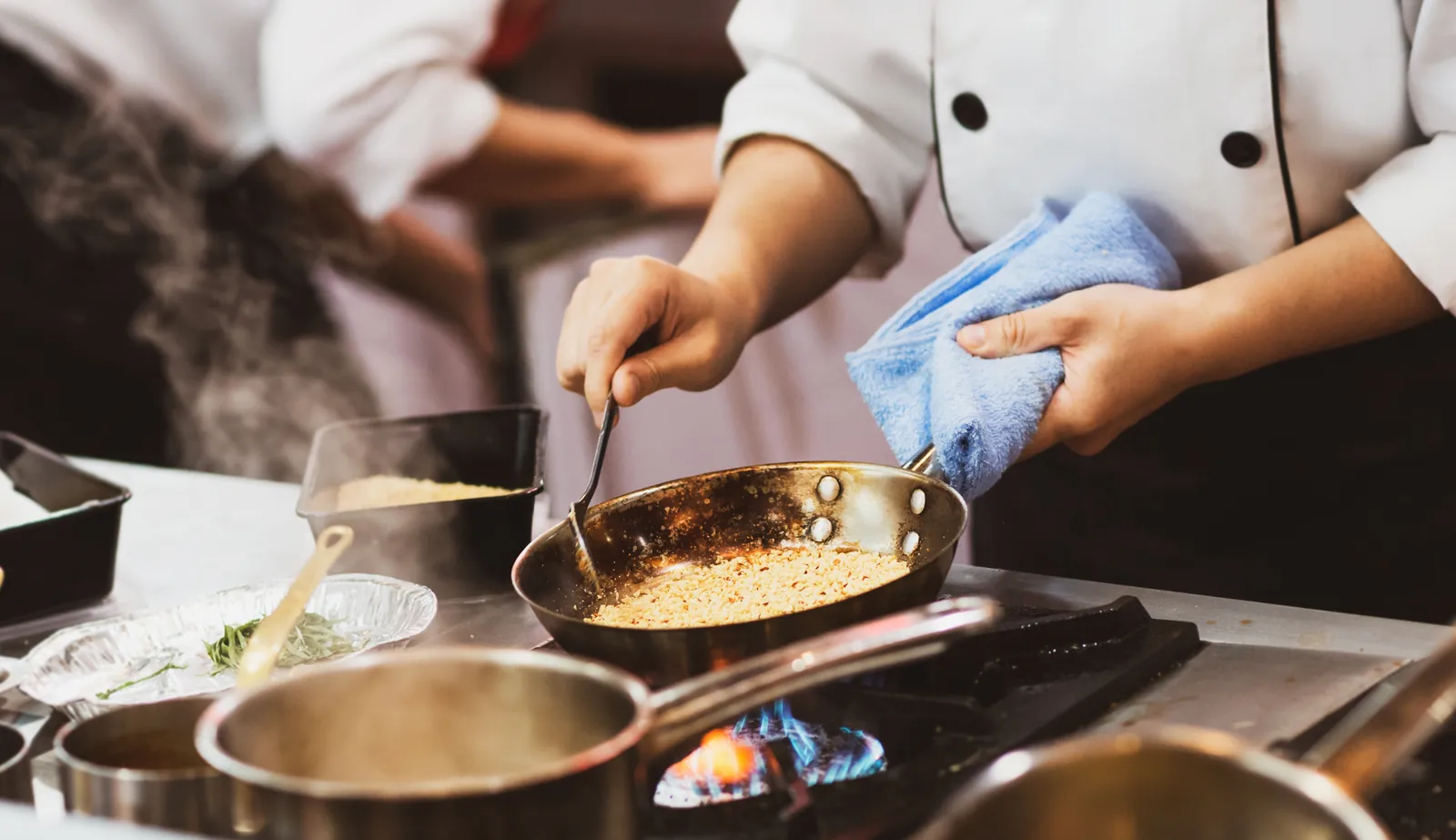 Chef cooking in a busy restaurant kitchen
